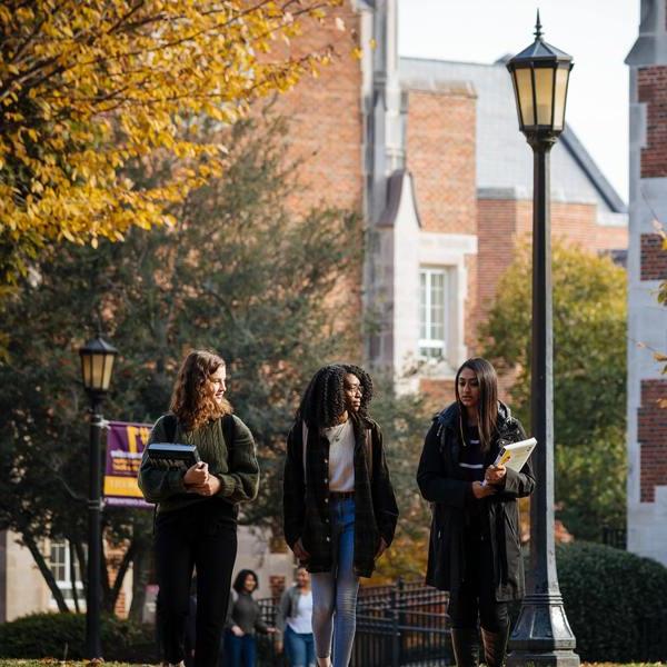 three female students walking on campus